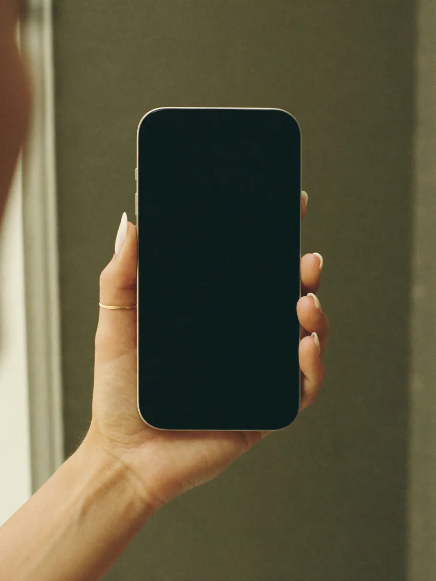 Eine Hand hält ein iPhone mit der Studio-App